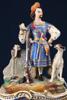 Bordspendyl, 1800-talets slut, jägare med jakthund, bemålad och förgylld keramik, höjd 39 cm